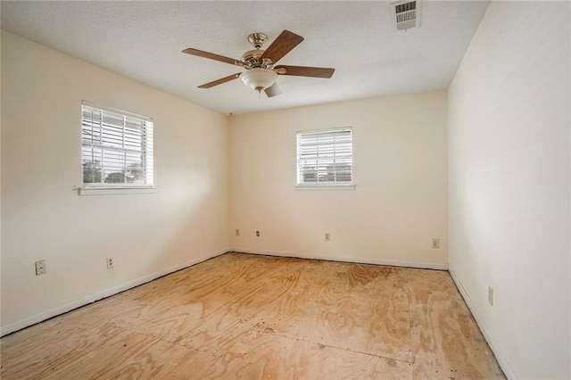 spare room with ceiling fan and a textured ceiling