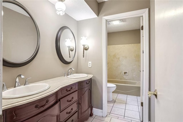 bathroom with toilet, a textured ceiling, vanity, and tile patterned floors