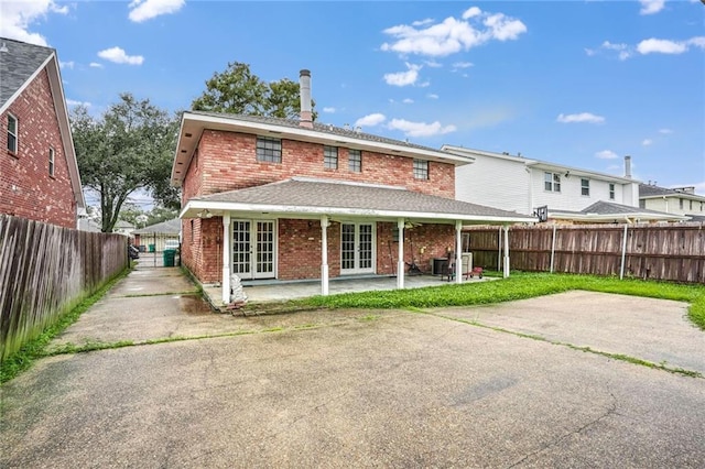 rear view of house featuring a patio area and french doors