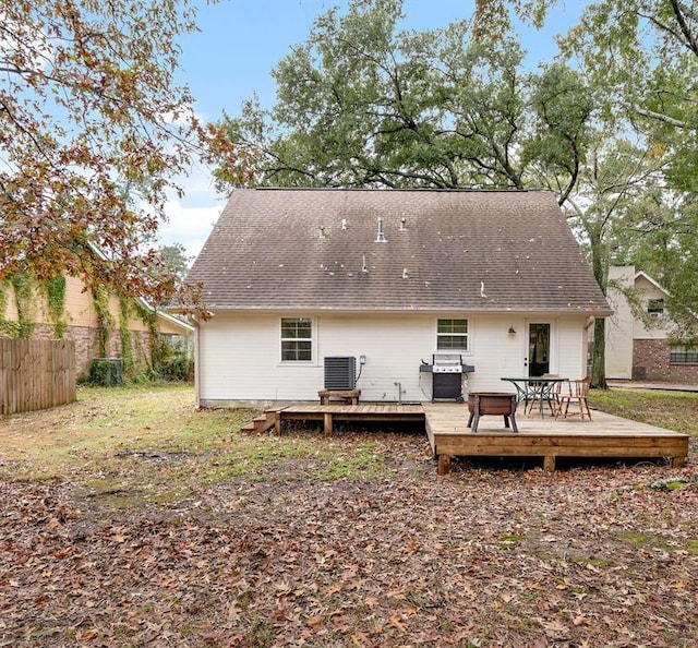 back of house featuring a wooden deck and central AC