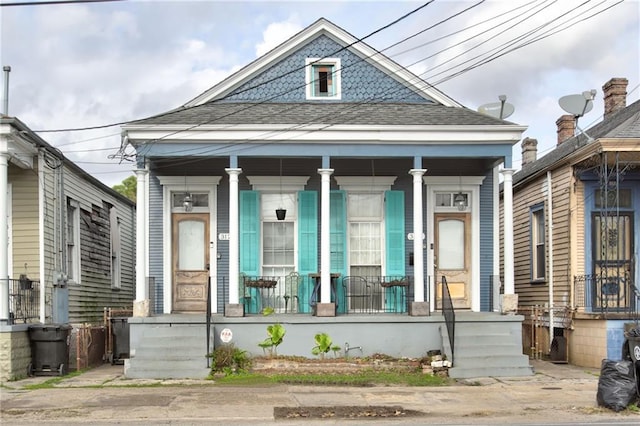 312931 N Claiborne Ave, New Orleans, LA 70117 - view of front facade with a porch and a shingled roof