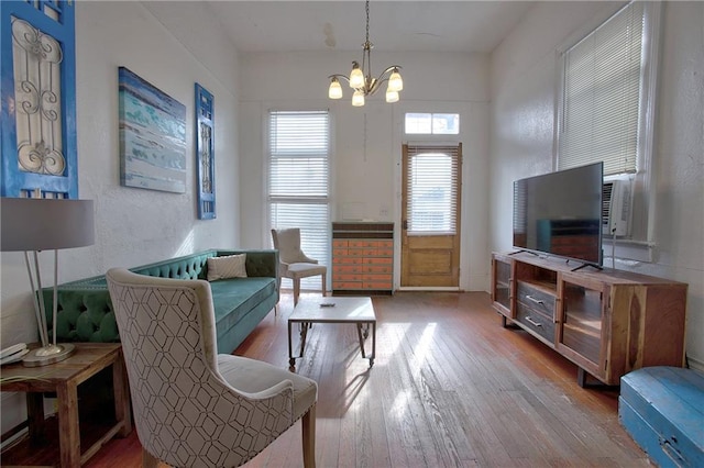 living room featuring hardwood / wood-style floors and a notable chandelier