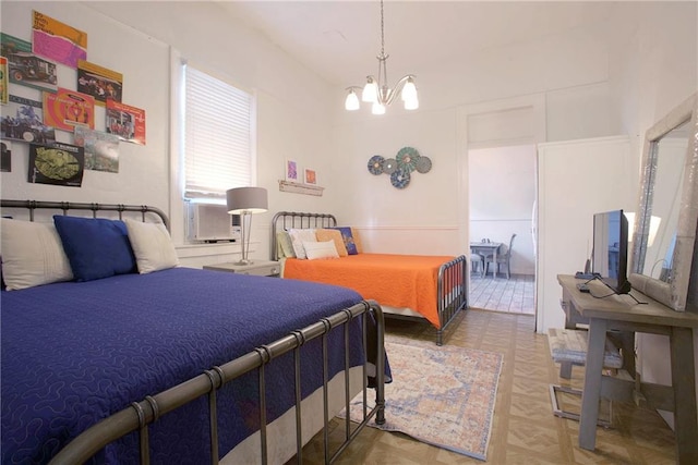 bedroom with cooling unit, parquet flooring, and a chandelier