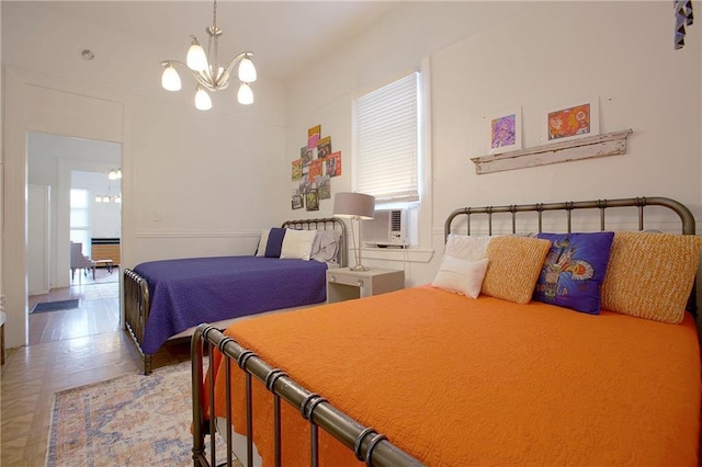 bedroom with multiple windows, cooling unit, and an inviting chandelier