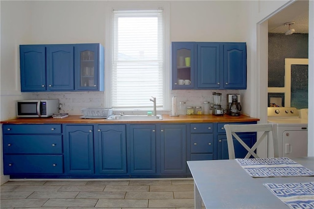 312931 N Claiborne Ave, New Orleans, LA 70117 - kitchen featuring stainless steel microwave, blue cabinets, butcher block counters, and a sink