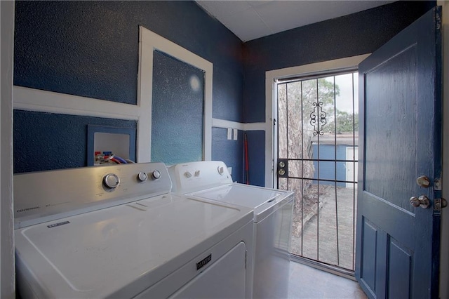 312931 N Claiborne Ave, New Orleans, LA 70117 - laundry area with a textured wall, laundry area, and washer and clothes dryer