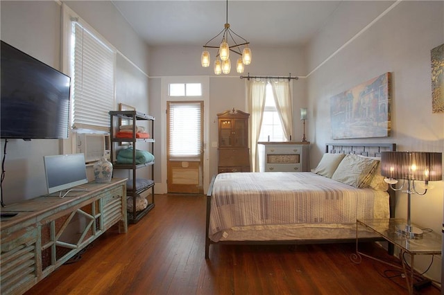 bedroom featuring dark hardwood / wood-style floors and a notable chandelier