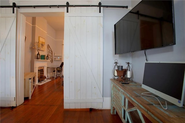 interior space featuring a barn door and dark hardwood / wood-style flooring