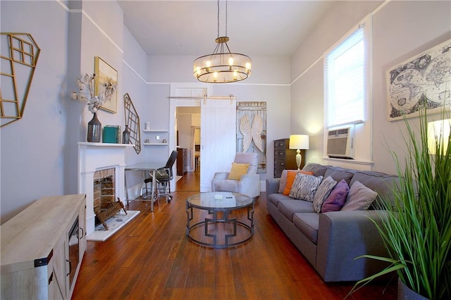 living room with dark hardwood / wood-style floors, cooling unit, and an inviting chandelier