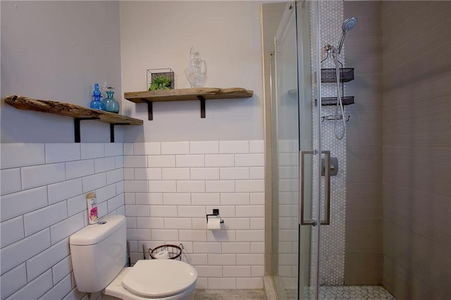 312931 N Claiborne Ave, New Orleans, LA 70117 - bathroom with a wainscoted wall, a shower stall, toilet, and tile walls