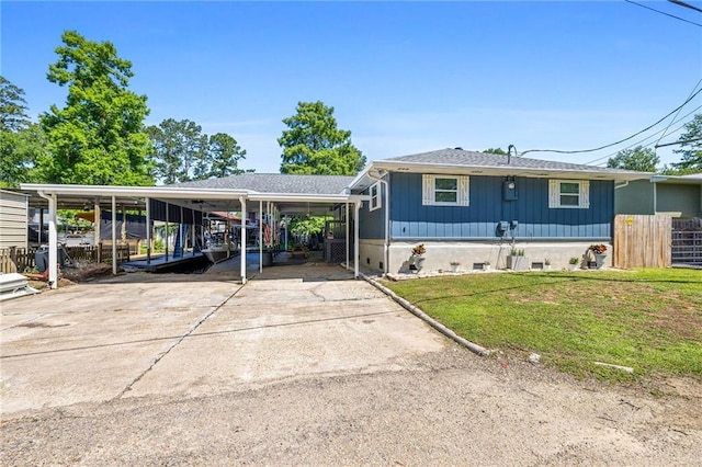 view of front of property with a carport and a front yard