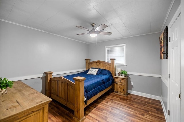 bedroom featuring ceiling fan, dark hardwood / wood-style flooring, and crown molding