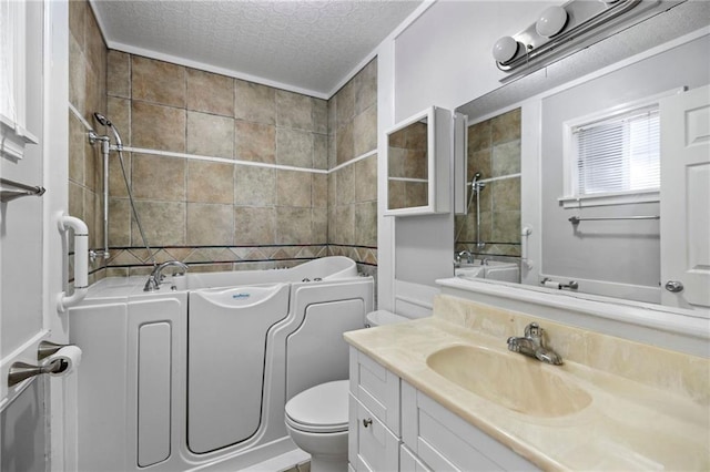 bathroom featuring vanity, toilet, and a textured ceiling