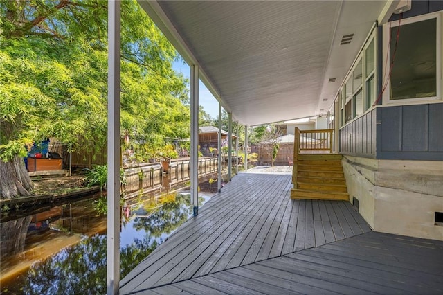 wooden terrace featuring a water view