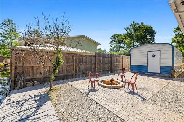 view of patio with a fire pit and a storage unit