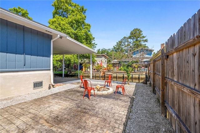 view of jungle gym featuring a patio and a fire pit