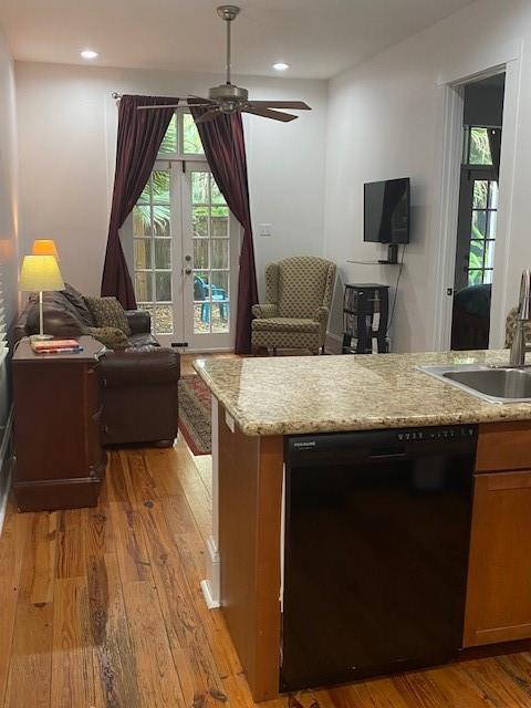 kitchen featuring french doors, light stone counters, ceiling fan, light hardwood / wood-style flooring, and dishwasher