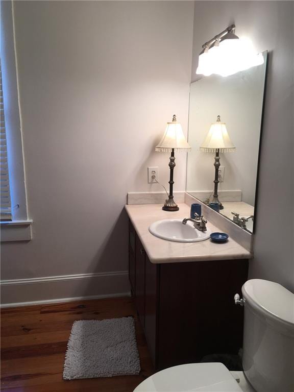 bathroom featuring hardwood / wood-style flooring, vanity, and toilet