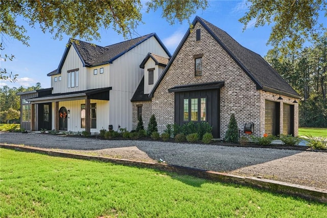 modern farmhouse with a porch and a front lawn