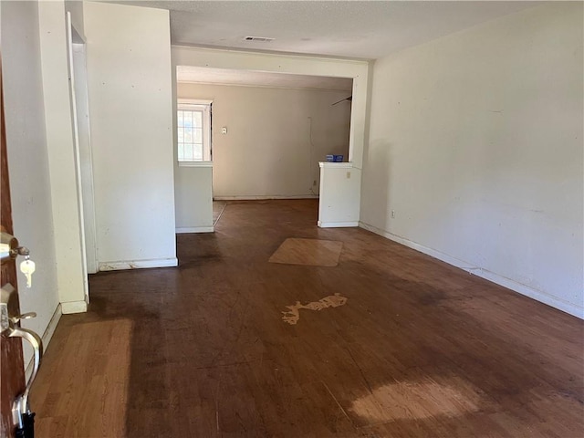 unfurnished room with dark hardwood / wood-style floors