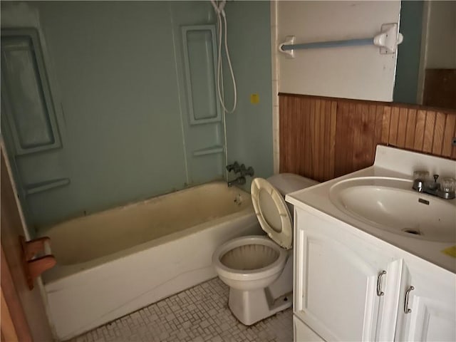 full bathroom with vanity, shower / bathing tub combination, tile patterned flooring, toilet, and wood walls