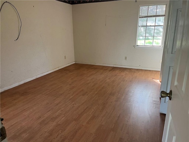 spare room with hardwood / wood-style floors