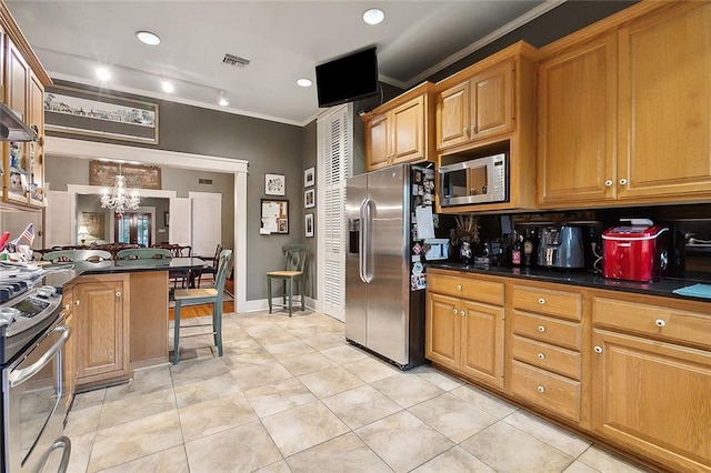 kitchen featuring appliances with stainless steel finishes, ornamental molding, a chandelier, hanging light fixtures, and light tile patterned flooring