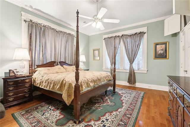 bedroom featuring hardwood / wood-style flooring, ceiling fan, and crown molding