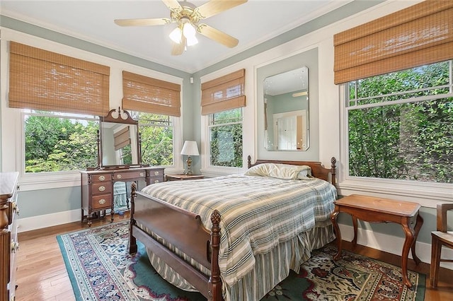 bedroom featuring ceiling fan, hardwood / wood-style floors, and ornamental molding