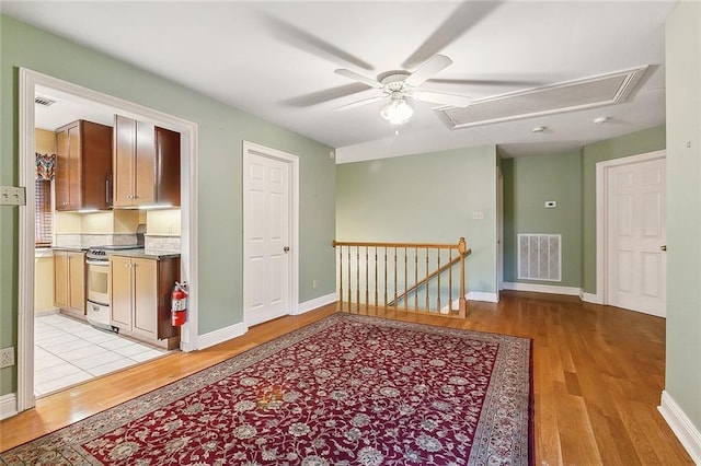 corridor with light hardwood / wood-style flooring