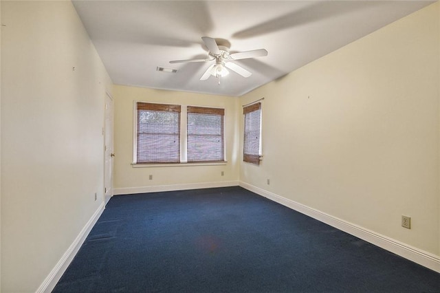 carpeted empty room featuring ceiling fan