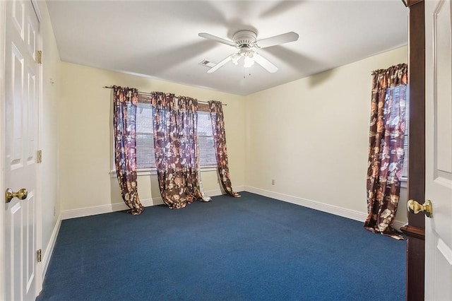 carpeted spare room featuring ceiling fan