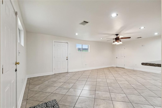 tiled spare room with ceiling fan