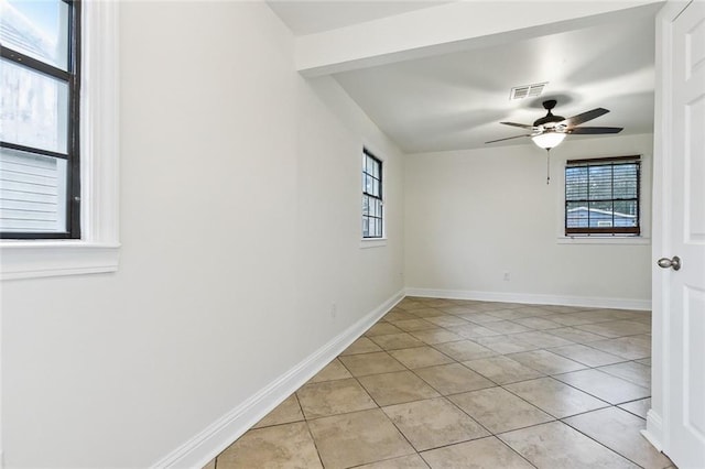 tiled empty room with ceiling fan