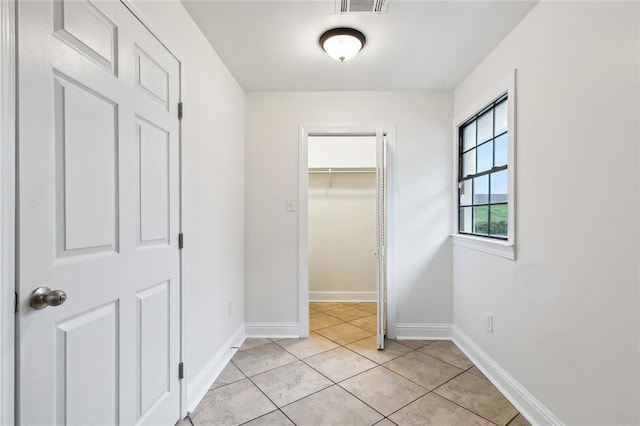 corridor featuring light tile patterned floors