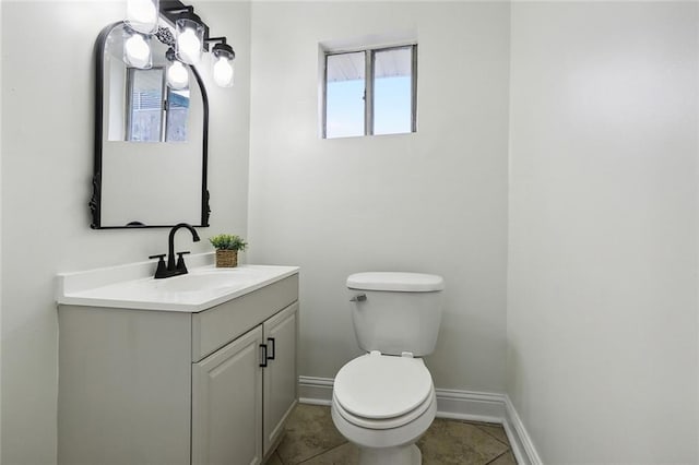 bathroom featuring tile patterned floors, vanity, and toilet