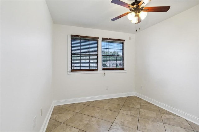 empty room featuring ceiling fan and light tile patterned flooring