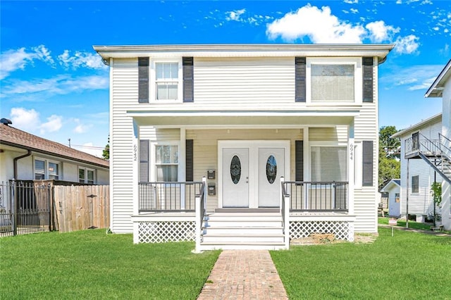 view of front of home featuring a front lawn and covered porch