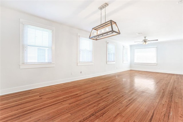 spare room featuring hardwood / wood-style floors, plenty of natural light, and ceiling fan