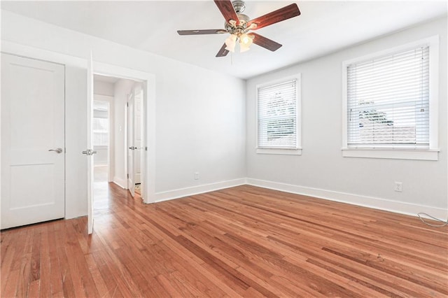 spare room with ceiling fan and light wood-type flooring