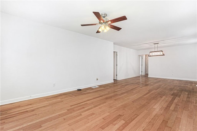 spare room with light wood-type flooring and ceiling fan