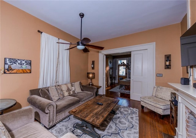 living room featuring dark hardwood / wood-style floors and ceiling fan