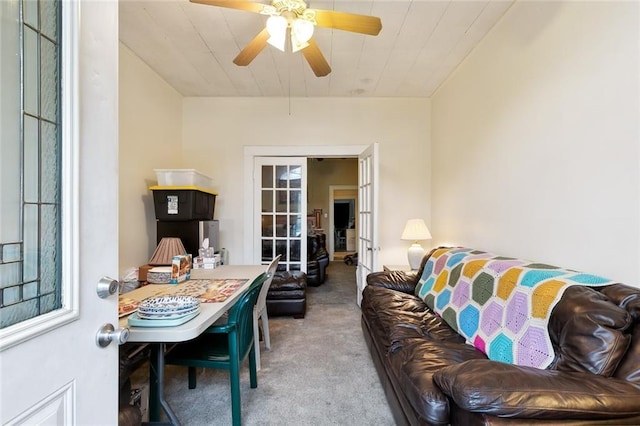 living room with ceiling fan, french doors, and carpet