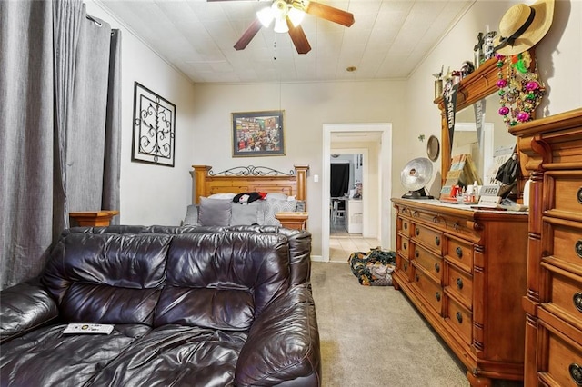 bedroom with ceiling fan and light carpet