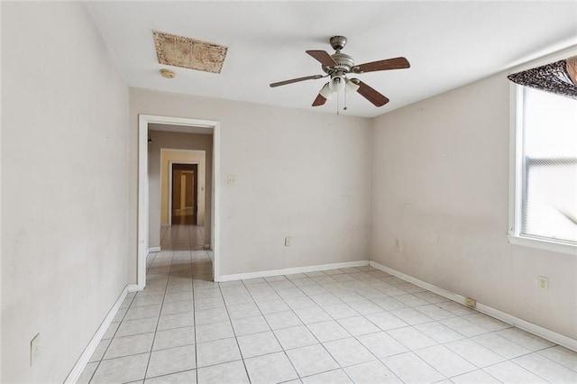 unfurnished room with ceiling fan and light tile patterned flooring