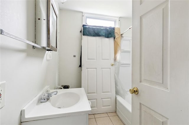 bathroom featuring tile patterned flooring, vanity, and shower / bathtub combination