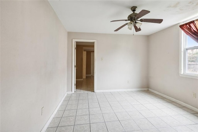 spare room featuring light tile patterned floors and ceiling fan