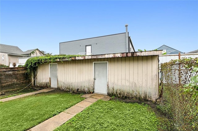 view of outbuilding with a yard