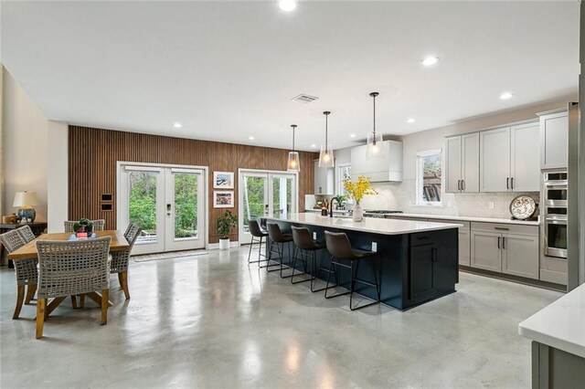 dining space with a chandelier, a towering ceiling, and concrete floors