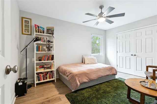 bedroom with ceiling fan, a closet, and light wood-type flooring